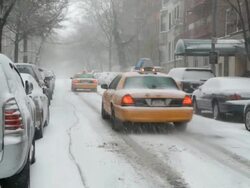 WS View of Biker and two cabs moving on street during winter / New York City, New York, USA  Stock Footage