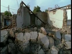 MS pan right across rubble of collapsed house, after earthquake, Gujarat, India Stock Footage