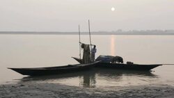 Fisherman return to the banks of the River Jamuna Bangladesh at sunset to unload sell auction and share their catch of small fish before tending to nets and returning home Stock Footage
