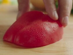  CU R /F Shot of half organic red bell pepper on kitchen cutting baord, vegetable cut into multiple slices with steel knife / Los Angeles, California United States Stock Footage