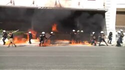 Anti-austerity protesters throw petrol bombs at police, ground shots News Clip