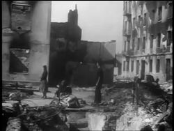 B/W 1939 tilt up people standing amidst rubble after German bombings / Warsaw, Poland / documentary Stock Footage