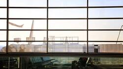 Airport boarding area with plane taking off Stock Footage