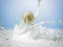 HD Super Slow-Mo: Banana Slices Splashing Into Milk Stock Footage