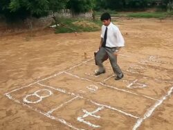 Businessman playing hopscotch, Haryana, India Stock Footage