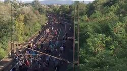 European Migrant Crisis: Migrants crossing railway Bicske tracks News Clip