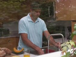 MS Shot through outside window of man washing dishes and looking outside / Portland, Oregon, United States Stock Footage