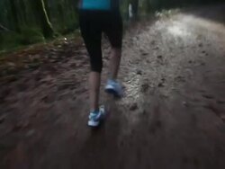 Mixed race woman running on forest path Stock Footage