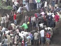 People climbing river bank after crossing river Stock Footage