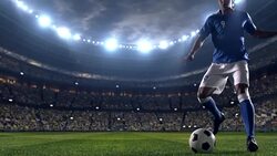 Soccer player dribbling a ball on the field Stock Footage