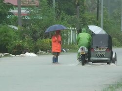 Motorbike driving through flood waters 60km NE of Laoag, Philippines, typhoon Parma 4th October 2009 Stock Footage