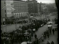 B/W 1960's high angle of civil rights march in city street / SOUND Stock Footage