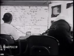 1966: UNITED AIRLINES CONTROL CENTER: VS Men working in office. DRAMATIZATION: Man telling 'Phil' SOT about radio problem on flight 191. HA TD United jet turning on tarmac mark. Unidentified man SOT telling 'Frank' 191 plane change, 10;00, gate 80. Instructional Video