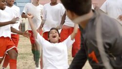 Youth soccer team rushes to hug player and celebrate winning goal Stock Footage