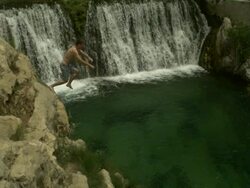 High Speed Man jumping from rocks into waterfall pool, Spain. (Individual frames may also be used as a still image. Each frame in its raw state is about 6MB or about 12MB as a 16 bit TIFF) Stock Footage