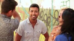 Young Brazilian friends chat by graffitied wall in Rio de Janeiro Stock Footage