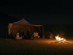 Mauritanian people in their tent singing at night at fireplace Stock Footage