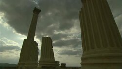 Storm clouds loom over columns at the Oudna Amphitheater ruins in Tunisia. Stock Footage