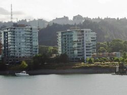 WS Shot of Modern glass apartments on water with boat in front / Portland, Oregon, United States  Stock Footage