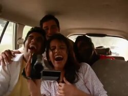 Couple watching pictures in a video camera in a car  Stock Footage