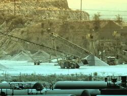 WS backhoe drives across cement plant  Stock Footage