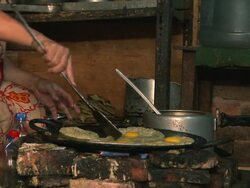 Nepali woman cooking food on a frying pan. Stock Footage
