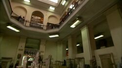 Museum patrons stand on a balcony above an exhibit of Ancient Egypt. Stock Footage