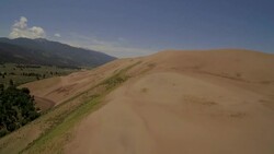 Fly over Great Sand Dunes, gaining altitude. Stock Footage