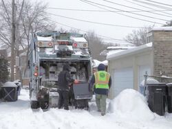 WS Sanitation workers working in snow covered alley Stock Footage