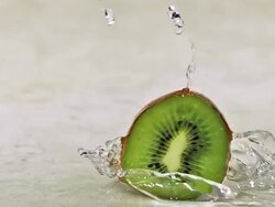 CU SLO MO Shot of Kiwi Fruits, actinidia chinensis, Slice rolling on Water and splashing / Calvados, Normandy, France Stock Footage