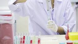 Girl in a laboratory pipette filled with sample. Stock Footage