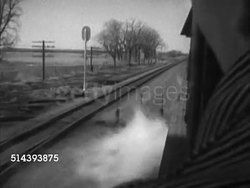 1953: UNION PACIFIC FREIGHT TRAIN:  VS Freight train (pulled by steam locomotive engine 9031, westbound) passing by two eastbound trains, engineer Art Franks driving, talking briefly (SOT), conductor Gabe Conant standing in caboose, looking out. Instructional Video
