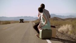 Anxious hitchhikers thumb for a ride, ignored by passing van Stock Footage