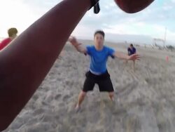 A group of young men playing flag football on the beach. - Slow Motion Stock Footage