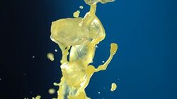 Beverage splash on blue background Stock Footage