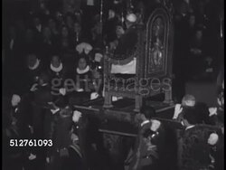 1950: VATICAN CITY: Pope Pius XII (1876-1958) being carried in sedia gestatoria (papal chair) back through center of Basilica Sancti Petri (St. Peter's Basilica), gesturing to Bless crowd BG. Instructional Video