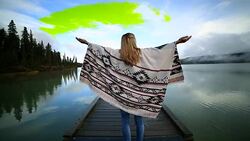 Woman outstretches arms on wooden pier by the lake Stock Footage