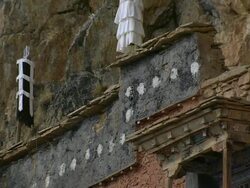 CU View of roof and wall detail of Tsakang gompa tibetan buddhist monastery / High Himalayas, Upper Dolpo near Tibetan border, Nepal Stock Footage