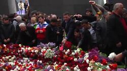 Mourners place flowers at memorial, comment Instructional Video