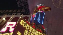Neon lights illuminate a sign of a cowboy in Las Vegas. Stock Footage
