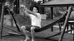 young man taking a selfie in the garden by smart phone B&W Stock Footage