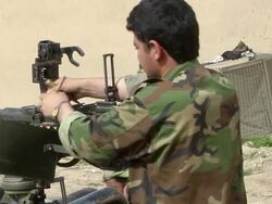 CU Soldier loading bullet in gun and taking position / Musa Qala, Helmand Province, Afghanistan. Stock Footage
