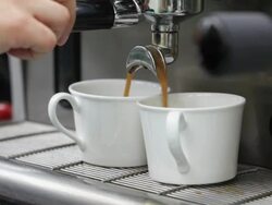 Coffee machine makes two cups of coffee, UK Stock Footage