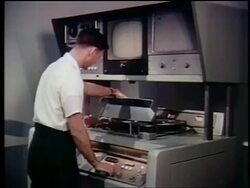 1962 man operating video tape machine / first satellite broadcast / documentary Stock Footage