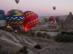 WS View of Hot Air Balloons Rise over Goreme Town in Cappadocia / Goremel, Turkey Stock Footage