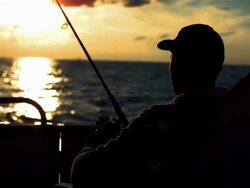 HD: Fishing From The Stern At Sunset Stock Footage