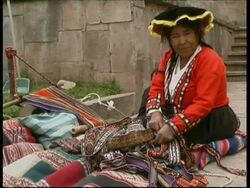 Inca woman in traditional clothes weaving colourful materials, Peru Stock Footage