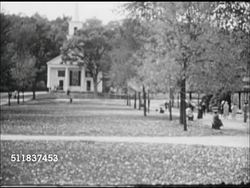 1957: AMERICANA ARCHITECTURE: Greek Revival house w/ columns front at edge of park, people walking, sitting on benches on tree lined path. LS Covered wooden bridge beyond bushes, Evergreen tree & wooden fencing. Instructional Video