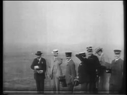 B/W 1900s men with hats shielding eyes to watch Wright brothers flight / documentary Stock Footage
