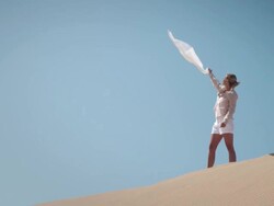 Woman with scarf in desert Stock Footage